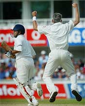 Sachin Tendulkar walks off as England pace bowler Andrew Caddick celebrates his dismissal