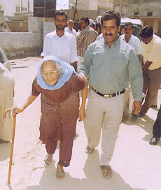 A woman being assisted by her son