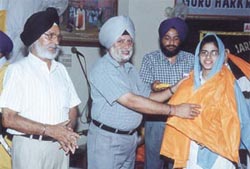 Students, parents and teachers of GHPS, Shahdara, take part in the �Amrit Chhakna� ceremony