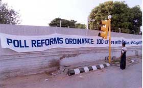 'Poll reforms ordinance-100 crore with Kalam 542 against' - a banner seen hanging on a wall 