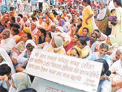 Widows wait for their turn at the 61st pension and ration distribution function