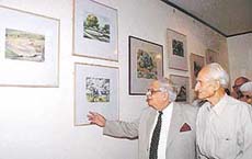 The UT Administrator, Lieut-Gen J.F.R. Jacob (retd), takes a look at the water colours put up by Baldev Rattan at Hotel Mountview in Chandigarh on Tuesday.