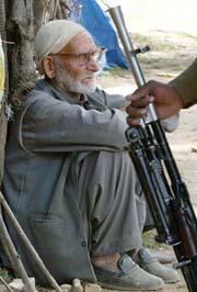 An elderly villager listens to Mehbooba Mufti
