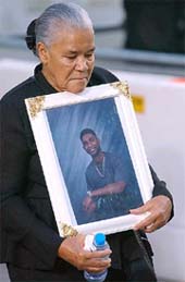 A woman carries a portrait