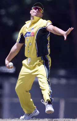 Australian spinner Shane Warne bowls during a practice match between the West Indies and Australia in Colombo
