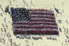 An aerial view shows that over 5000 people dressed in red white and blue form a human American flag in tribute to the victim of the September 11 attacks on the Surfers Paradise beach on the gold coast of Australia on Wednesday.