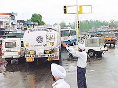 A Gypsy with a red light on top crosses the highway from a wrong direction at the defunct traffic lights on the Chandigarh-Ambala and the Panchkula-Patiala national highway intersection at Zirakpur on Thursday
