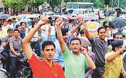 Students of city colleges march through Chandigarh on Thursday carrying umbrellas to protest against Panjab University decisions