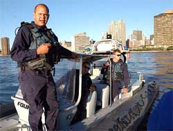 Coast Guard officers check a boat on the East River 