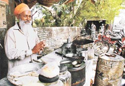 Ujjagar Singh selling �paranthas� at a dhabha outside Gate No. 3 of the PAU