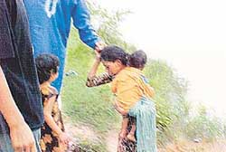 Meenakshi being rescued after she attempted suicide by drowning in the Abohar feeder canal near Rara Sahib village