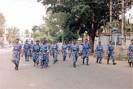 Rapid Action Force jawans patrol a road during the Bangalore bandh
