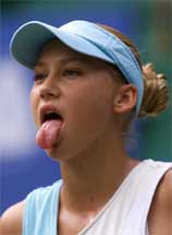 Russian tennis star Anna Kournikova sticks out her tongue after scoring a point against Chinese player Zheng Jie