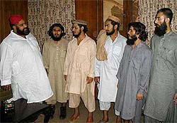 Tahir Mehmood Ashrafi, left, advisor to governor on religious affairs, welcomes Pakistani militants
