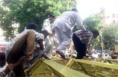 Activists of Lok Janshakti Party crossing the barricade