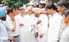The local MP, Mr Pawan Kumar Bansal, discusses a point with a sarpanch
