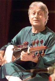 Musician Amjad Ali Khan plays the traditional Indian instrument