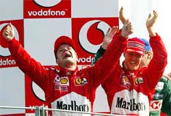 Brazilian Ferrari driver Rubens Barrichello raises his arms in celebration
