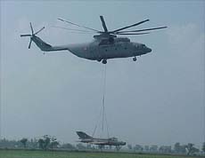 A helicopter carries the MiG 21