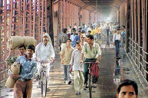 Even though the old Yamuna bridge has been closed to vehicular traffic owing to the surging water level, pedestrians continued to use it as a thoroughfare on Monday.