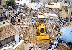 A bulldozer clears the debris
