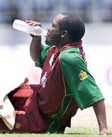 Brian Lara sips water as he takes rest during the pool match between West Indies and Kenya in the ICC Champions Trophy in Colombo