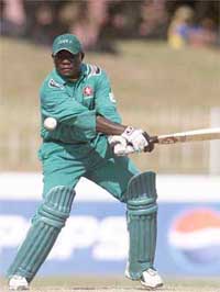 Kenya�s captain Steve Tikolo drives a delivery to the fence