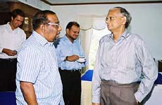 Sri Lankan government chief negotiator G. L. Peiris talks with his Tamil Tiger counterpart