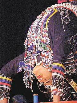 A Kabalia dancer from Rajasthan lifts a razor with her eyelashes during a performance