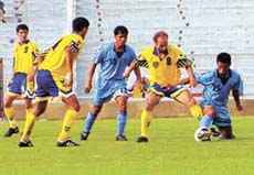Indian captain Baichung Bhutia goes for a sliding tackle against Uzbek midfielder Pirmatov Ottabek in the exhibition football match between India and Uzbekistan at the Ambedkar Stadium 