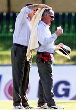 Australian umpire Darryl Harper wipes the sweat off South African officiating umpire