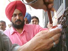 Excise and Taxaion officials sealing the main gate of Gagan Cinema