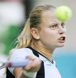 Defending champion Jelena Dokic of Yugoslavia eyes the ball as she makes a return to Russian Lina Krasnoroutskaya 