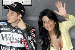 Brazilian hometown hero Moto GP rider Alex Barros relaxes in the pits lane garage