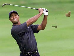 Tiger Woods of the USA plays on the sixth fairway