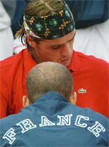 France Davis Cup team captain Guy Forget speaks with Arnaud Clement during his match