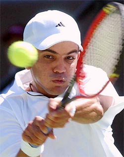 India's Harsh Mankad plays a shot during his match