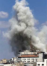 Smoke rises from buildings inside Palestinian President Yasser Arafat's compound