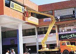 Illegal hoardings being removed in Sector 9 in Chandigarh on Saturday. 