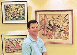 Rahul Bakshi along with his paintings at IndusInd Art Gallery in Sector 8, Chandigarh