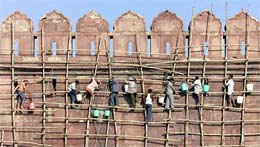 Cleaners use wooden scaffoldings