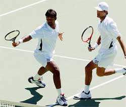 India's Leander Paes plays a shot during his double match