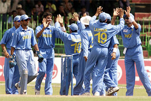 The Indian cricket team celebrates the dismissal of England's Marcus Trescothick, who failed to score during the pool match