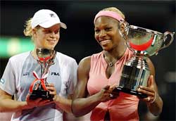 World number one Serena Williams of the United States smiles with runner-up Kim Clijsters of Belgium
