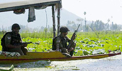 Securitymen patrol the famous Dal lake