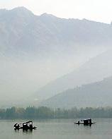 Kashmiri people row their boats on the Dal Lake