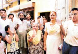 Residents of street no. 8, New Shiv Puri, show contaminated water being supplied to their houses