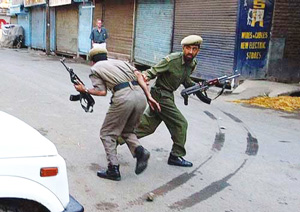 Policemen run during clashes