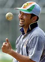Sachin Tendulkar laughs as he tosses the ball