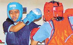 A young pugilist makes a move against his opponent